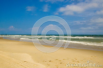 Footsteps on the beach on a sunny day Stock Photo