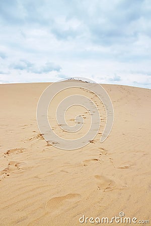 Footsteps leading to the top of Dune of Pilat in France Stock Photo