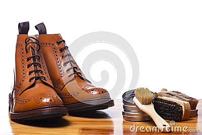 Footwear Ideas and Concepts. Closeup of Tanned Mens Derby Boots With Cleaning Accessories and Wax Stock Photo