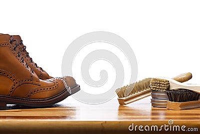 Footwear Ideas and Concepts. Closeup of Tanned Mens Derby Boots With Cleaning Brushes and Wax Stock Photo