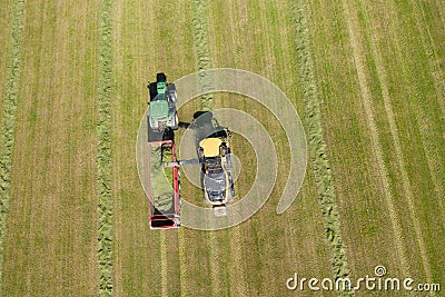 forage harvester and transport of grass with tractor and a loader wagon Stock Photo