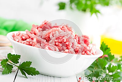 Forcemeat. Raw ground pork meat in bowl on white kitchen table. Fresh minced meat Stock Photo