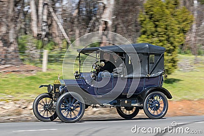 1915 Ford Model T Tourer driving on country road Editorial Stock Photo