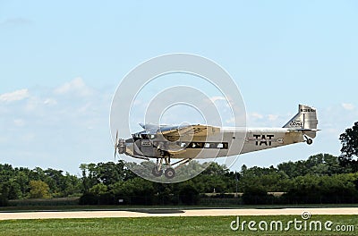 A Ford Tri-Motor Airplane lands at EAA AirVenture Editorial Stock Photo