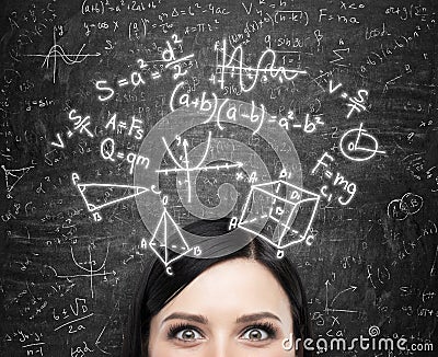 A forehead of the lady and maths formulas are drawn on the black chalkboard. Stock Photo