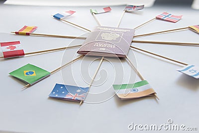 Foreign passport of Russian Federation and flags of different countries around: India, Brazil, UK,Italy, Norway, Australia Stock Photo