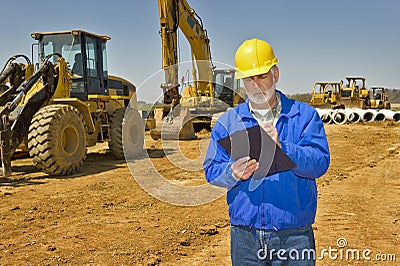 Foreman With Clipboard and Highway Construction Equipment Stock Photo