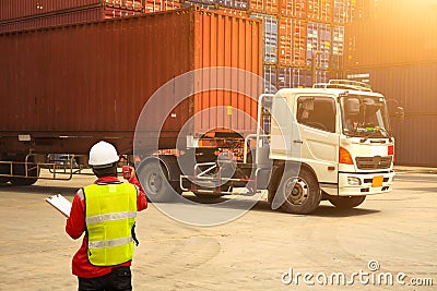 Foreman control loading Containers box to truck for Logistic Imp Stock Photo