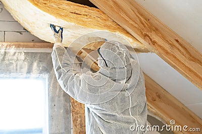 Foreman in overalls working with rockwool insulation material Stock Photo