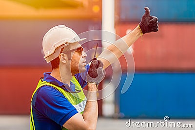 Foreman shipping staff worker working radio control loading cargo port logistic for import export goods at container warehouse Stock Photo