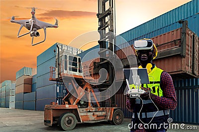 Foreman or worker use remote controller piloting drone at containers port for checking container. Foreman use remote control Drone Stock Photo