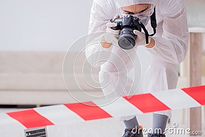 The forensic expert at crime scene doing investigation Stock Photo