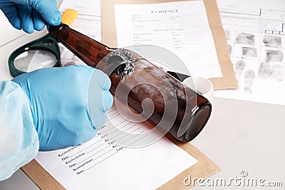 Forensic fingerprint analysis, criminalist collects latent fingerprints using fingerprint powder Stock Photo