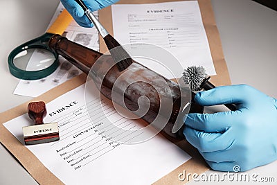 Forensic fingerprint analysis, criminalist collects latent fingerprints using fingerprint powder Stock Photo