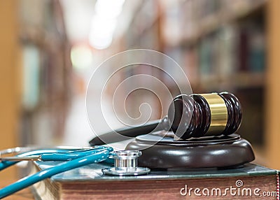 Forensic medicine investigation or malpractice justice concept with judge gavel and medical stethoscope on law textbook in library Stock Photo