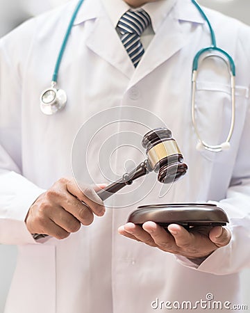 Forensic medicine legal investigation or medical practice - malpractice justice concept with judge gavel in doctor`s hands Stock Photo