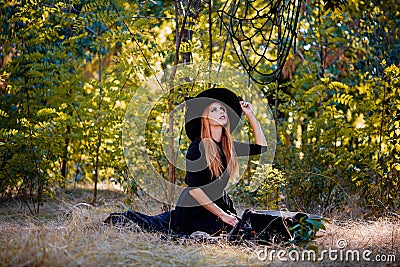 The forest enigmatic witch in the green wood outdoors. Stock Photo