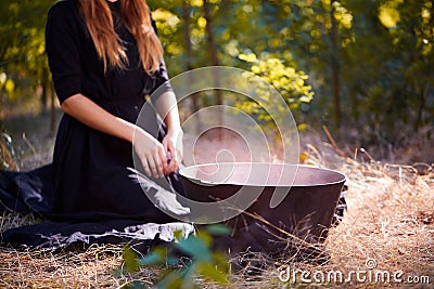 The forest enigmatic witch in the green wood outdoors. Stock Photo