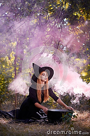 The forest enigmatic witch in the green wood outdoors. Stock Photo