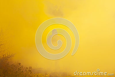 Forest fires, silhouette of a firefighter in fiery smoke extinguishes the forest with water, natural smoke screen Stock Photo