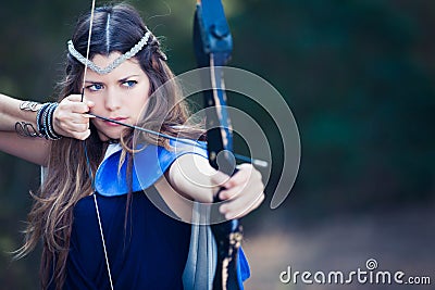 Forest hunter girl with bow and arrow Stock Photo