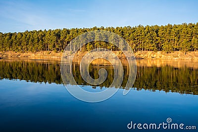 The forest and its mirror image in a river Stock Photo