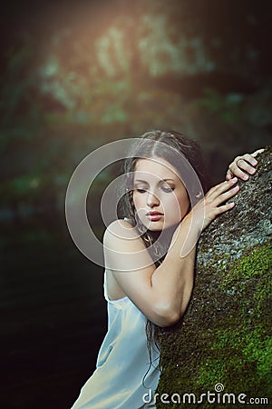 Forest nymph posing in a green pond Stock Photo