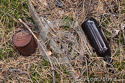 Forest pollution with garbage plastic bottles, glass bottles, metal rust cans Stock Photo