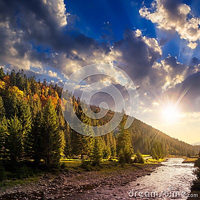 Forest river in autumn mountains at sunset Stock Photo