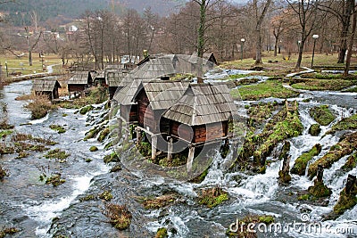 Forest river and wooden water mills Stock Photo