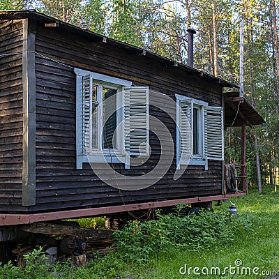 Forest warden's hut forest lodge, small house of Forester in the old pinery taiga, boreal forest in vintage style Stock Photo