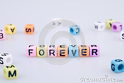 Forever word text written on colorful cube with bokeh cube word Stock Photo