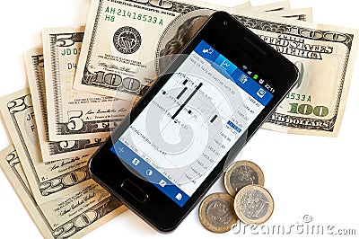 Forex trading by mobile phone and money Stock Photo