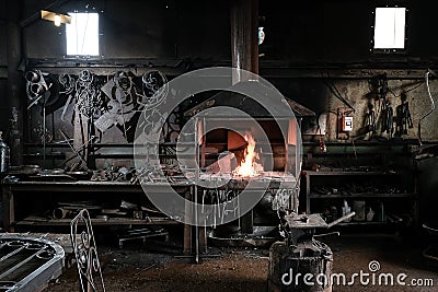 Forge, production workshop. Blacksmith tools and hot metal. Stock Photo