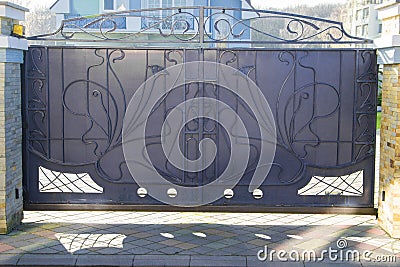 Forged gates and gate. Front of the house. Stock Photo