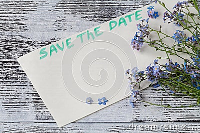 The forget-me-not branch on a card with pgrase save the date Stock Photo