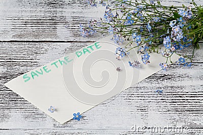 The forget-me-not branch on a card with pgrase save the date Stock Photo