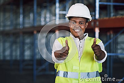 Forget safety first, how about safety forever. Portrait of a young woman working showing thumbs up at a construction Stock Photo