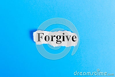 Forgive text on paper. Word Forgive on a piece of paper. Concept Image Stock Photo