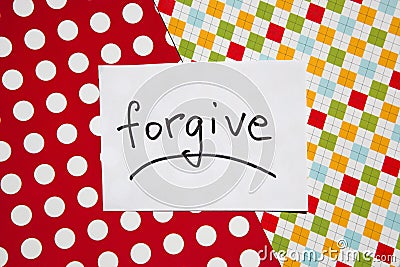 Forgive - word on white real paper with colorful background, relationship concept Stock Photo