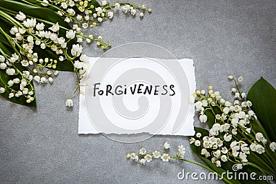 Forgiveness word with white flowers Stock Photo