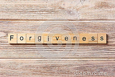 Forgiveness word written on wood block. forgiveness text on table, concept Stock Photo