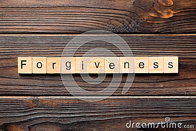 Forgiveness word written on wood block. forgiveness text on table, concept Stock Photo