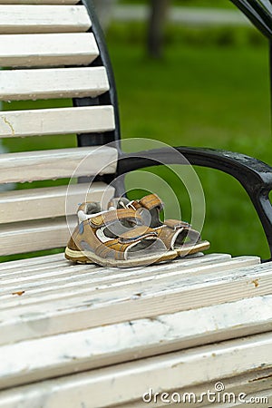 Forgotten children`s shoes on a park bench Stock Photo