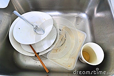 Forgotten dirty dish in sink. Top view of unclean plate in sink. Stock Photo
