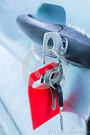 Forgotten keys inserted into car door lock Stock Photo