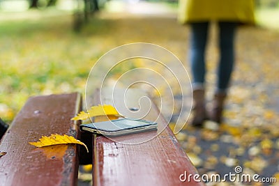 Forgotten smartphone on a park bench Stock Photo