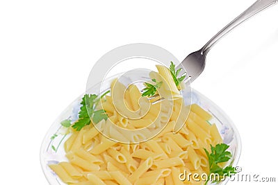 Fork with cooked cylinder-shaped pasta over dish with pasta Stock Photo