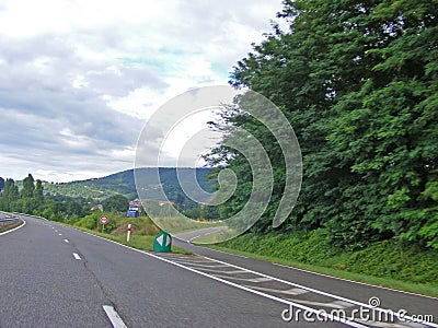 Fork junction sign with crossroads spliting in two way. Roads, view from car Stock Photo