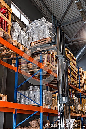 Fork lifter with pallet in warehouse. Forklift loader in storage warehouse ship yard. Distribution products. Delivery Stock Photo